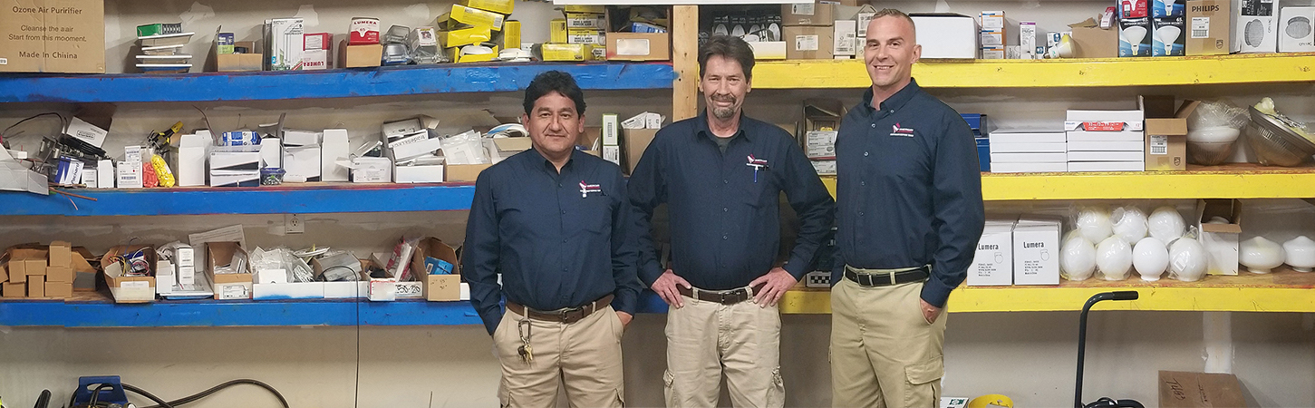 Three men in a warehouse