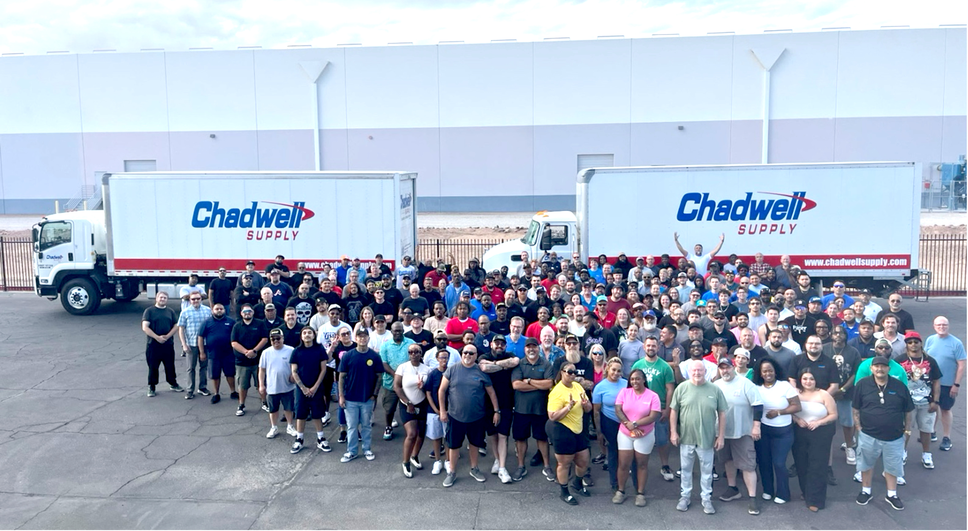 Chadwell Supply team gathered in front of two delivery trucks at the Phoenix branch